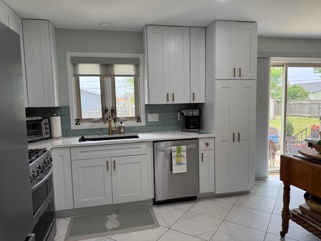4005 86th Pl, Kenosha, WI 53142 - kitchen with stainless steel appliances, light countertops, and backsplash