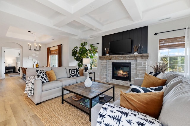 1887 Woodland Way, Slinger, WI 53086 - living area with light wood-type flooring, coffered ceiling, a chandelier, a fireplace, and beamed ceiling