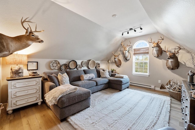 1887 Woodland Way, Slinger, WI 53086 - bedroom featuring a baseboard heating unit, lofted ceiling, and wood finished floors