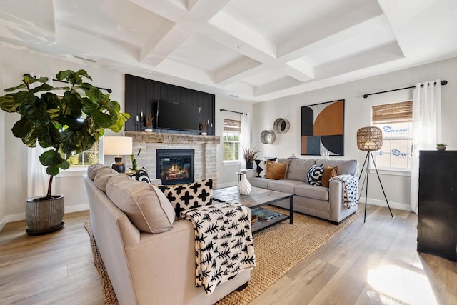 1887 Woodland Way, Slinger, WI 53086 - living room featuring coffered ceiling, a glass covered fireplace, light wood-type flooring, and beam ceiling