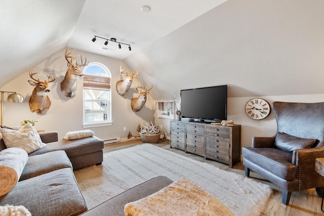1887 Woodland Way, Slinger, WI 53086 - living room with lofted ceiling, a baseboard heating unit, and wood finished floors