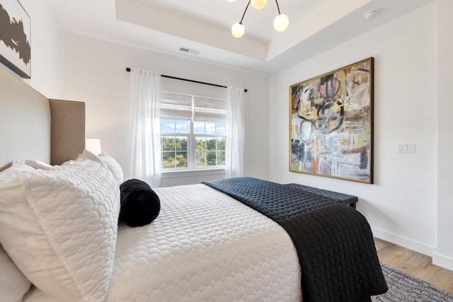 1887 Woodland Way, Slinger, WI 53086 - bedroom with wood finished floors and a tray ceiling
