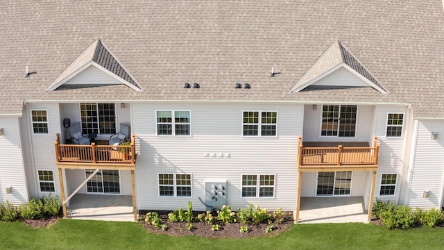 1887 Woodland Way, Slinger, WI 53086 - rear view of property featuring a balcony, a patio area, roof with shingles, and a lawn