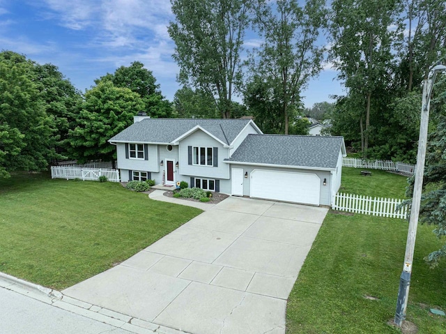 324 Nancy Ln, Pulaski, WI 54162 - raised ranch with an attached garage, driveway, a shingled roof, a chimney, and view of wooded area