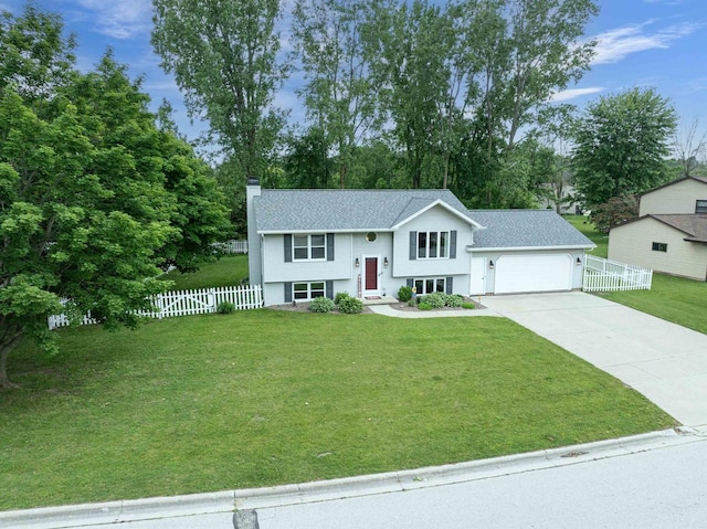 324 Nancy Ln, Pulaski, WI 54162 - bi-level home with a chimney, driveway, an attached garage, stucco siding, and roof with shingles
