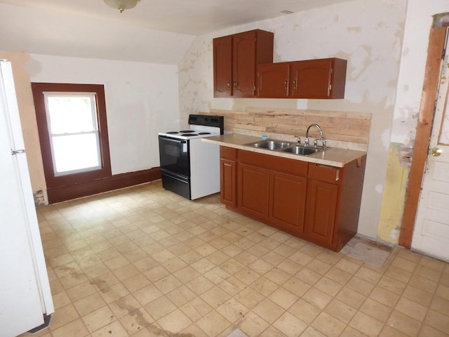 328 2nd St, Menasha, WI 54952 - kitchen with range with electric cooktop, freestanding refrigerator, lofted ceiling, light countertops, and light flooring