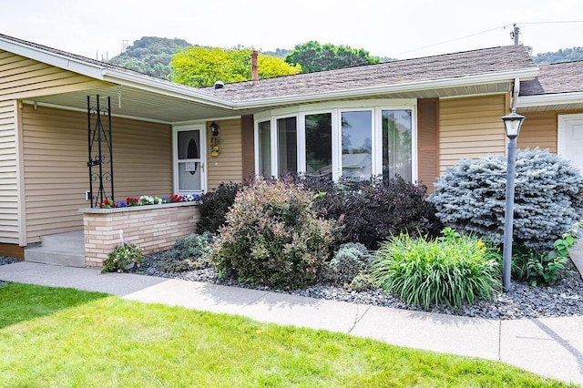 3424 Geneva Ln, La Crosse, WI 54601 - property entrance featuring roof with shingles and a porch
