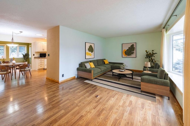 3424 Geneva Ln, La Crosse, WI 54601 - living area featuring healthy amount of natural light, light wood-style floors, and a textured ceiling
