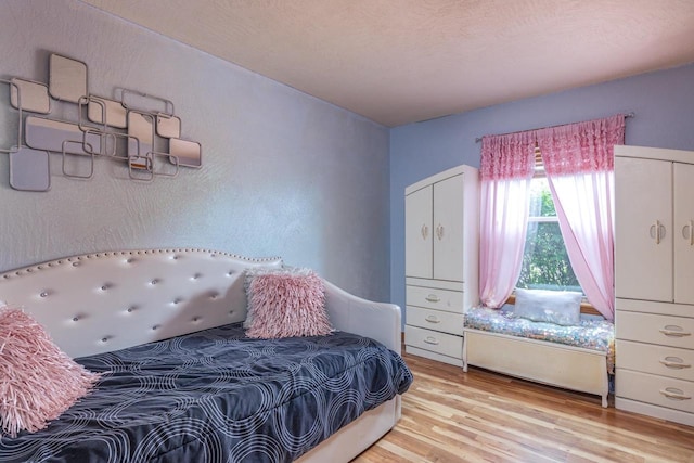 217 Lemongrass Way, Kaukauna, WI 54130 - bedroom with light wood-type flooring and a textured wall