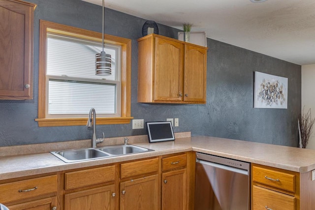 217 Lemongrass Way, Kaukauna, WI 54130 - kitchen featuring stainless steel dishwasher, a peninsula, light countertops, and decorative light fixtures