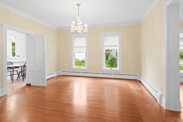 204 E Huron St, Berlin, WI 54923 - spare room with a chandelier, wood-type flooring, crown molding, and baseboard heating