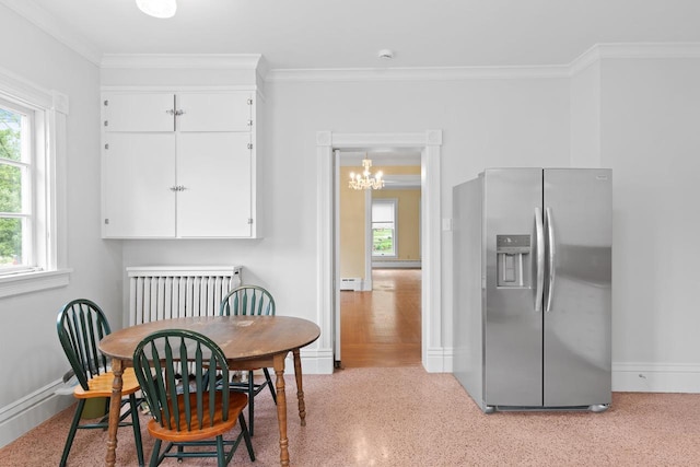 204 E Huron St, Berlin, WI 54923 - dining area with plenty of natural light, crown molding, a chandelier, radiator, and baseboard heating