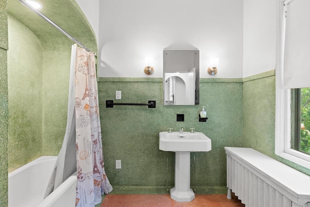 204 E Huron St, Berlin, WI 54923 - bathroom with radiator, shower / tub combo, and a wainscoted wall