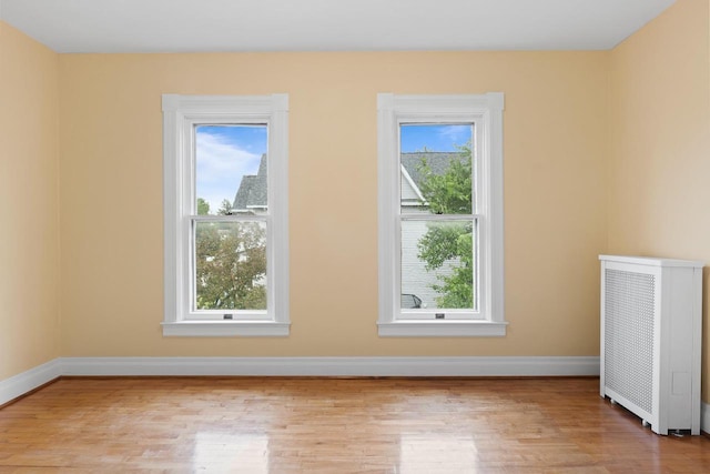 204 E Huron St, Berlin, WI 54923 - empty room with radiator and light wood-style floors
