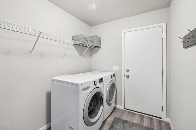 6017 Lyda Woods Ln, Madison, WI 53718 - laundry area featuring washing machine and clothes dryer and light wood finished floors