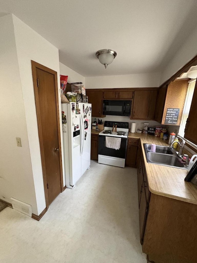 2712 Woodridge Ln, Waukesha, WI 53188 - kitchen with white appliances, light countertops, and dark brown cabinets