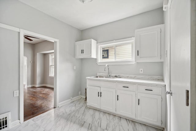 4059 N 7th St Unit 4059A, Milwaukee, WI 53209 - kitchen featuring white cabinetry, ceiling fan, light marble finish floors, and light stone counters
