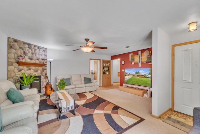 5542 W Jerelyn Pl, Milwaukee, WI 53219 - living room with light colored carpet, a ceiling fan, and a stone fireplace