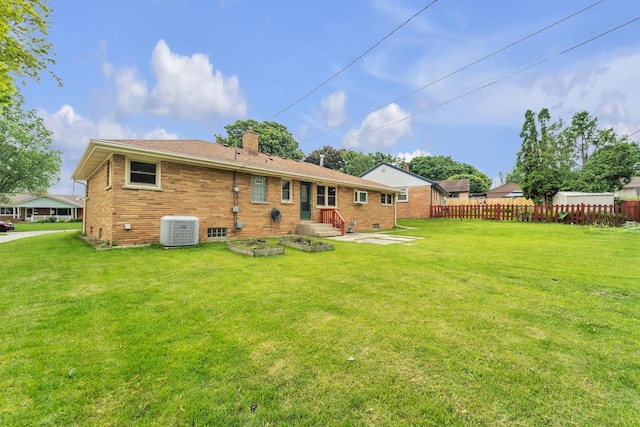 5542 W Jerelyn Pl, Milwaukee, WI 53219 - rear view of house with a chimney, brick siding, and a patio area