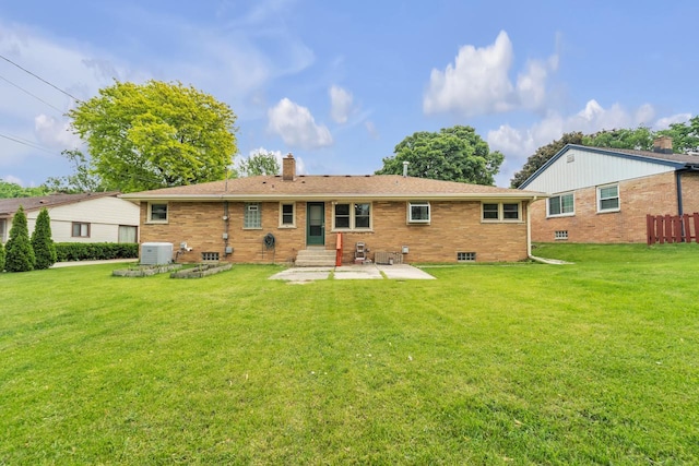5542 W Jerelyn Pl, Milwaukee, WI 53219 - rear view of house featuring a chimney, a patio area, brick siding, entry steps, and a yard