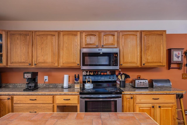 4114 Sheard Rd, Dover, WI 53139 - kitchen with appliances with stainless steel finishes, tile counters, and brown cabinets