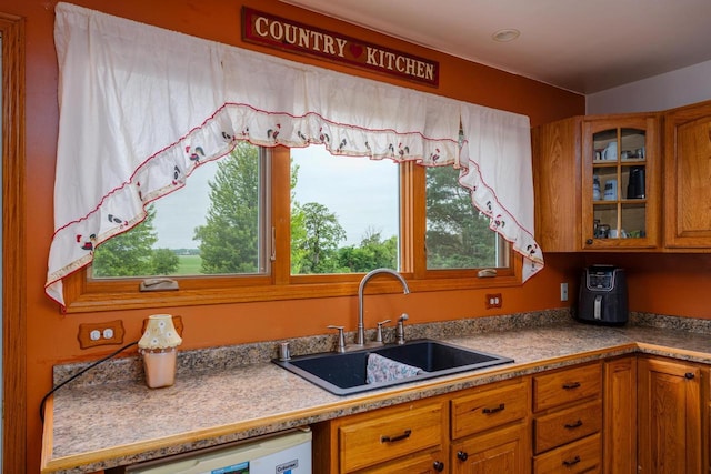 4114 Sheard Rd, Dover, WI 53139 - kitchen with brown cabinetry, dishwasher, and glass insert cabinets