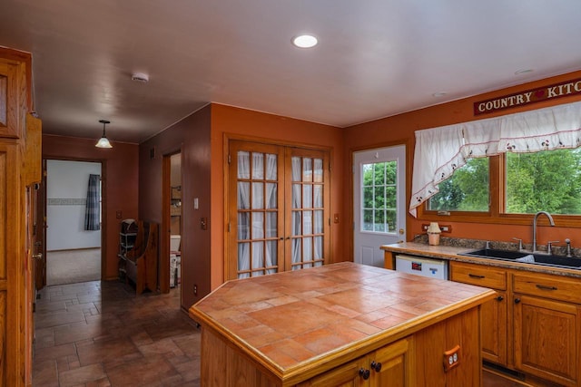 4114 Sheard Rd, Dover, WI 53139 - kitchen featuring stone tile floors, tile countertops, a center island, dishwasher, and recessed lighting