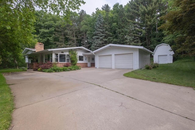 1718 N 13th St, Wausau, WI 54403 - ranch-style home featuring a chimney, a front lawn, brick siding, and an outbuilding