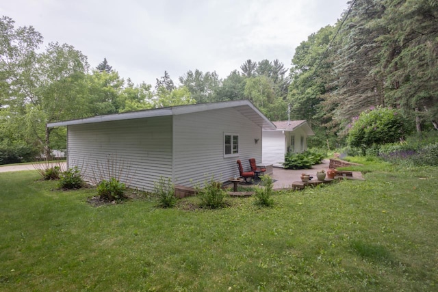 1718 N 13th St, Wausau, WI 54403 - view of side of property with a patio area and a yard