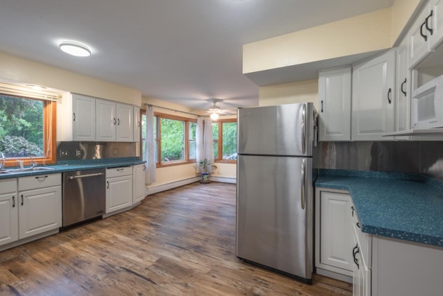 1718 N 13th St, Wausau, WI 54403 - kitchen featuring stainless steel appliances, dark wood-style floors, and dark countertops