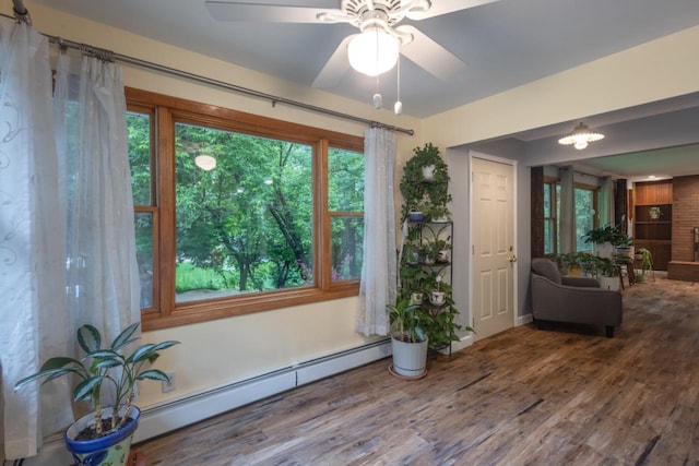 1718 N 13th St, Wausau, WI 54403 - sitting room featuring a baseboard heating unit, wood finished floors, and ceiling fan