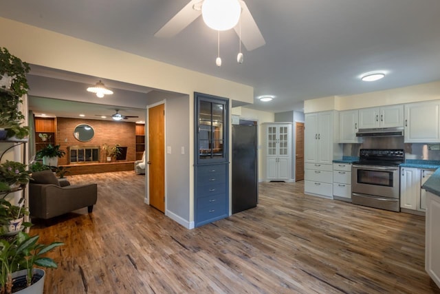 1718 N 13th St, Wausau, WI 54403 - kitchen featuring stainless steel electric range, ceiling fan, freestanding refrigerator, and dark wood-type flooring