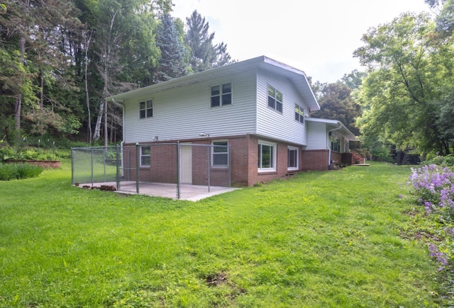 1718 N 13th St, Wausau, WI 54403 - back of house with a patio area, brick siding, and a yard