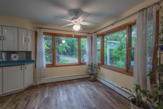 1718 N 13th St, Wausau, WI 54403 - unfurnished dining area featuring baseboard heating, healthy amount of natural light, and ceiling fan