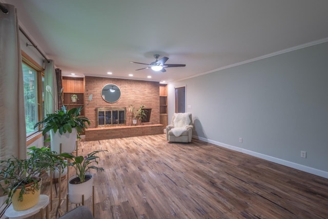 1718 N 13th St, Wausau, WI 54403 - living room featuring a ceiling fan, wood finished floors, a brick fireplace, recessed lighting, and ornamental molding