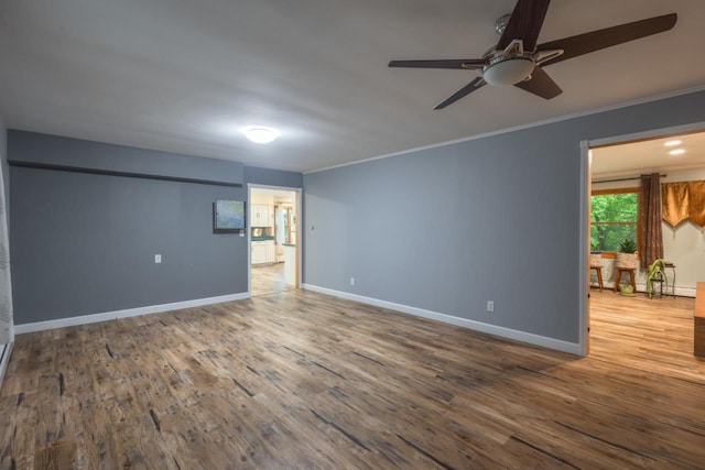 1718 N 13th St, Wausau, WI 54403 - spare room featuring ceiling fan, wood finished floors, and ornamental molding