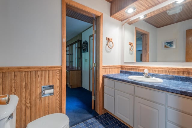 1718 N 13th St, Wausau, WI 54403 - half bathroom with wainscoting, vanity, and tile patterned floors