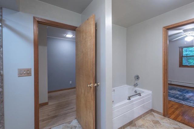 1718 N 13th St, Wausau, WI 54403 - bathroom featuring baseboard heating, a garden tub, and wood finished floors