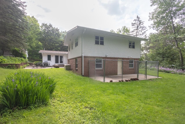 1718 N 13th St, Wausau, WI 54403 - back of property with a patio, brick siding, and a yard
