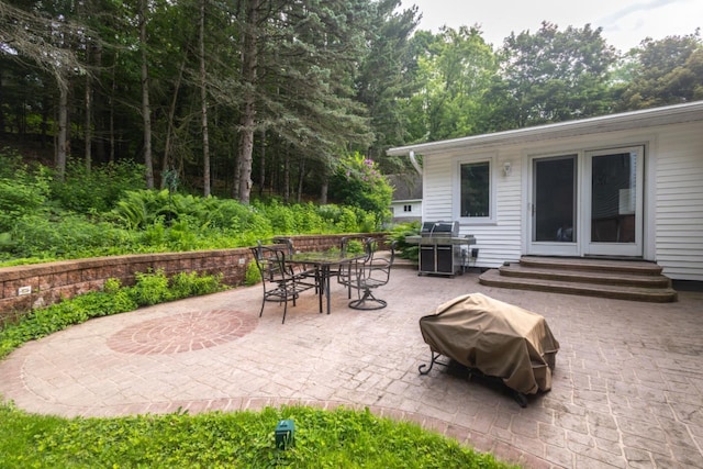 1718 N 13th St, Wausau, WI 54403 - view of patio / terrace featuring entry steps, outdoor dining space, and a grill