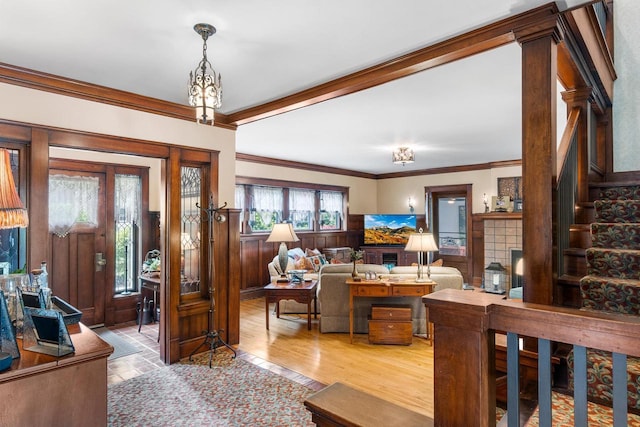 730 3rd St S, Wisconsin Rapids, WI 54494 - living room featuring ornamental molding, wainscoting, wood finished floors, and stairs