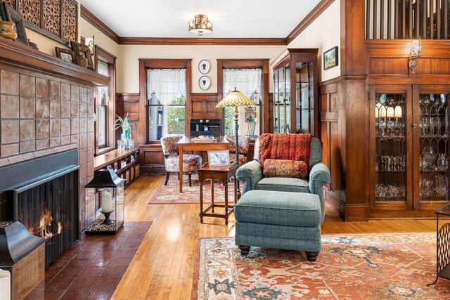 730 3rd St S, Wisconsin Rapids, WI 54494 - living area featuring a fireplace with flush hearth, crown molding, hardwood / wood-style flooring, and wainscoting