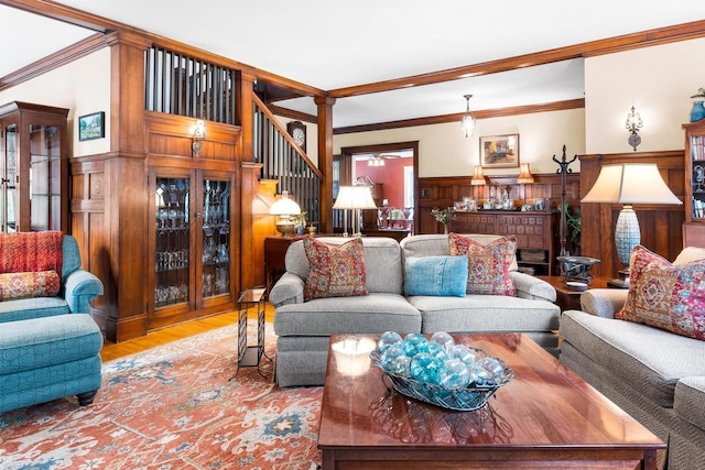 730 3rd St S, Wisconsin Rapids, WI 54494 - living room with stairway, wood finished floors, ornamental molding, wainscoting, and a ceiling fan