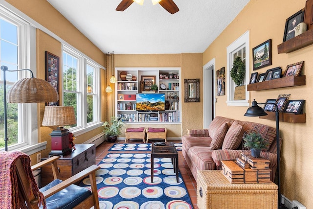 730 3rd St S, Wisconsin Rapids, WI 54494 - living room featuring a ceiling fan, baseboard heating, a textured ceiling, and a textured wall