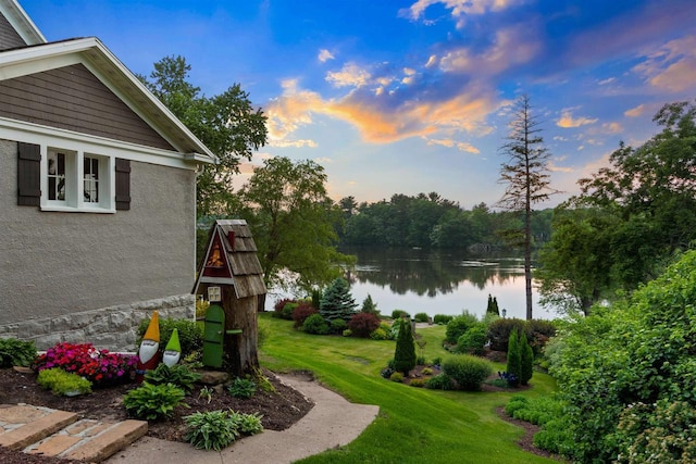 730 3rd St S, Wisconsin Rapids, WI 54494 - yard at dusk with a water view and a lawn
