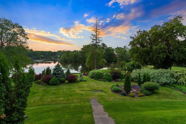 730 3rd St S, Wisconsin Rapids, WI 54494 - yard at dusk with a water view and a lawn