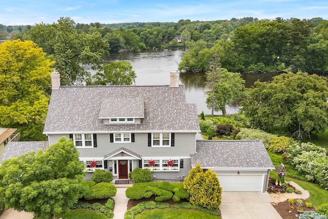 730 3rd St S, Wisconsin Rapids, WI 54494 - view of front of home with a chimney, a water view, a garage, and driveway