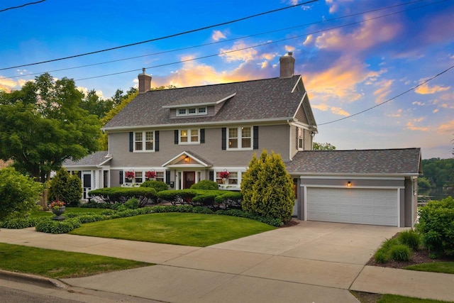730 3rd St S, Wisconsin Rapids, WI 54494 - view of front of home with a chimney, driveway, a front yard, and a garage
