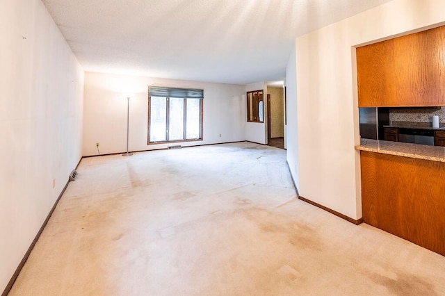 1311 Hickory St, Onalaska, WI 54650 - unfurnished living room featuring light carpet and baseboards