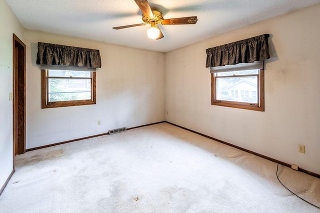 1311 Hickory St, Onalaska, WI 54650 - carpeted empty room with plenty of natural light and ceiling fan